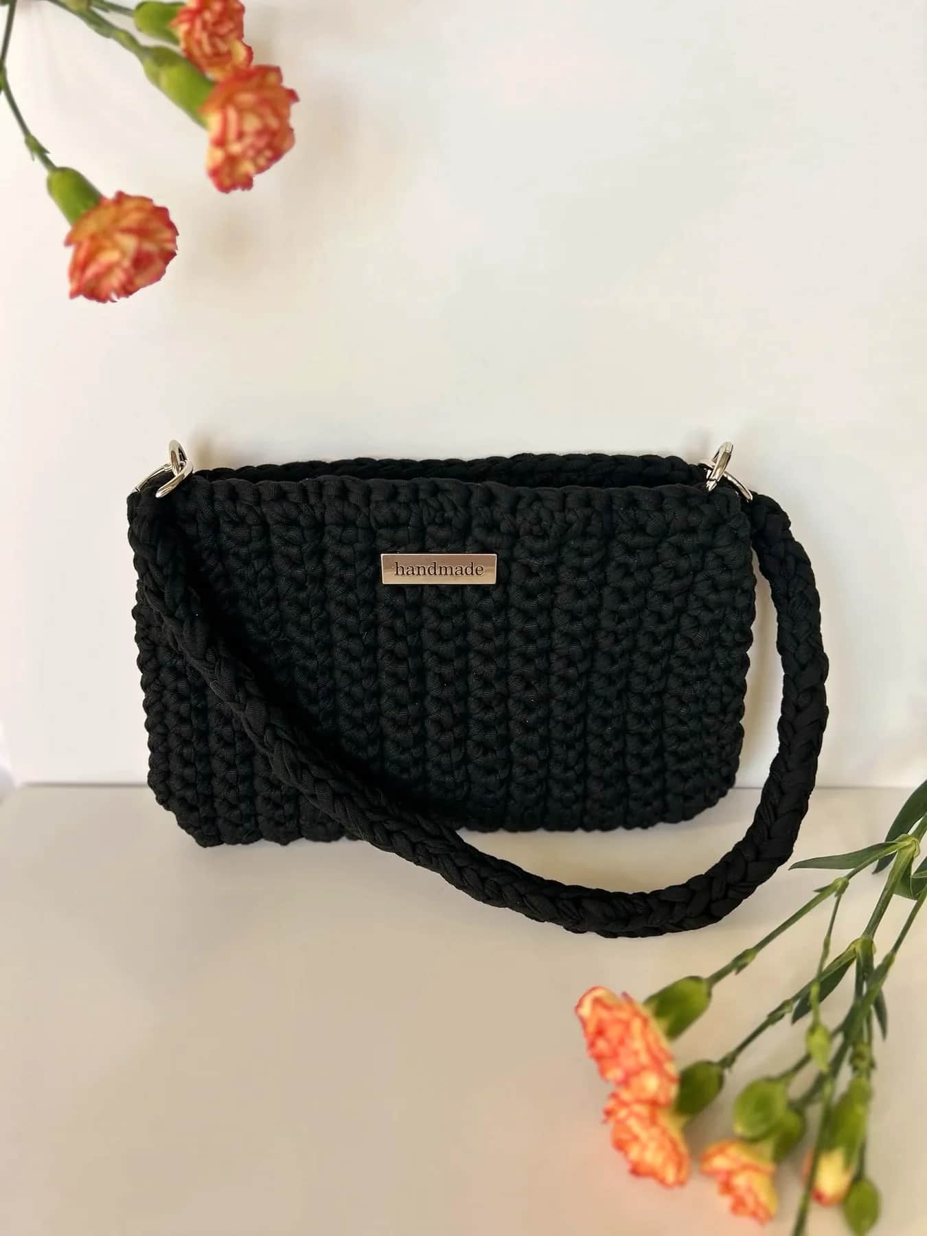 Black small crochet bag with a long matching strap
